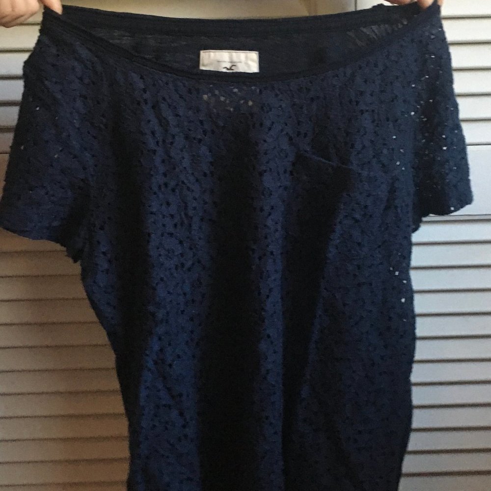 Navy blue shirt with a lace-like detail and pocket